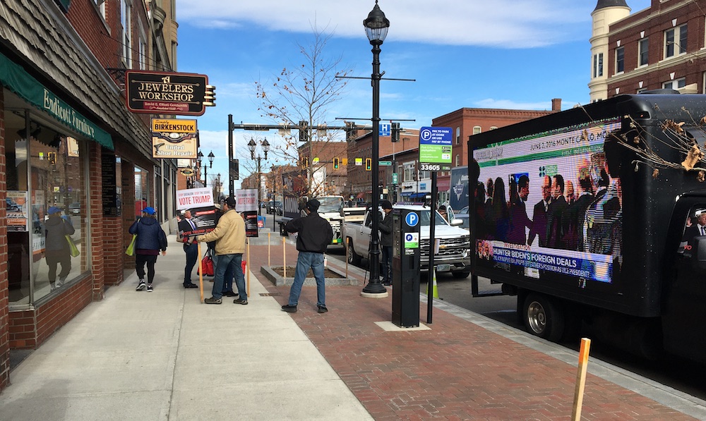 THE OTHER PROTEST: PRO-TRUMP TRUCK FLASHES HIGH-WATTAGE TV CLIPS ABOUT DEMS OUTSIDE NEW HAMPSHIRE CLIMATE TOWN HALL